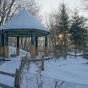 Antique gazebo in the middle of a open water fowl premise.
