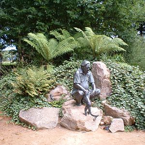 Statue of Gerald Durrell with a black and white ruffed lemur at Jersey Zoo,