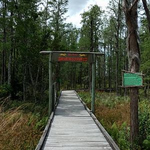 Entrance sign by parking lot.