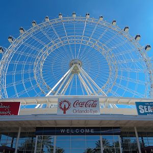 Exterior with Orlando Eye rising above I Drive 360 entertainment complex