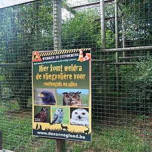 Unoccupied bird-of-prey aviary and sign