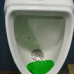 Original male urinary with a fly painted inside