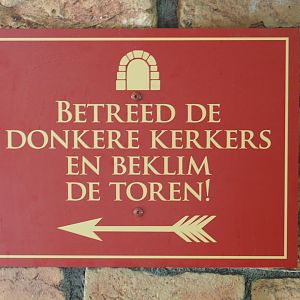 Enter the dungeons and climb the tower sign