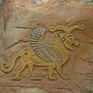 Weird mythological creature wall relief