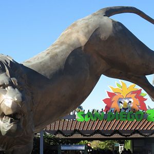 Lion statue and zoo entrance sign