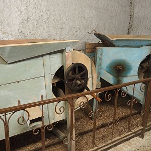 Assorted objects in the entrance corridor to the tropical house - Old agricultural processing machinery, 2019-08-04