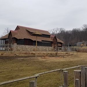 Turtle Back Zoo - Giraffe house, with lion exhibit in background
