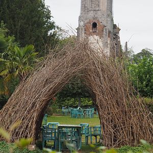 Sitting area with old chairs underneath bowerbird-inspired wicker structure, 2020-09-03
