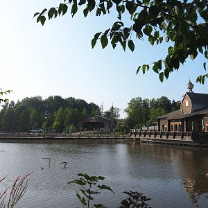 VIew over lake with Russian restaurant L'Izba, pontoon terrace and theming hangar, 2021-09-02