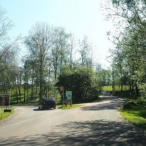 Road to parking lot (left side) and access to drive-through safari (right side), 2023-05-19