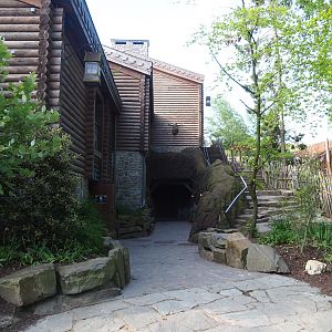 Building with penguin cave, restrooms and hotel rooms, and stairs alongside reindeer paddock, 2023-05-16