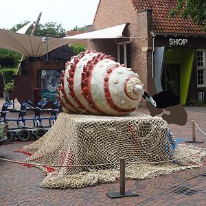Recycled materials artwork exhibition - Hermit crab made from plastic and fishing nets, Ticket checkpoint and shop in background, 2023-08-17