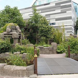Monkey Ruins exhibit next to entrance building and entrance square, 2024-06-23
