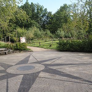 Walkway towards entrance, square with compass rose and cattle paddock in the entrance area, 2024-08-21