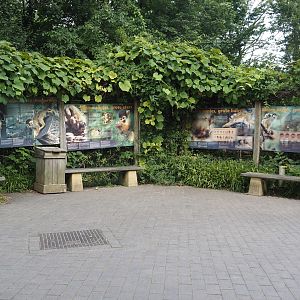 Seating and signage near the entrance of the squirrel monkey forest, 2024-08-21