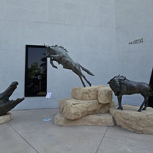 African statues crocodile and wildebeasts, Dubai crocodilepark