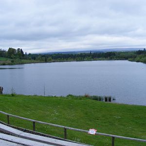 Loch in front of birds of prey display arena at Blair Drummond Safari Park,