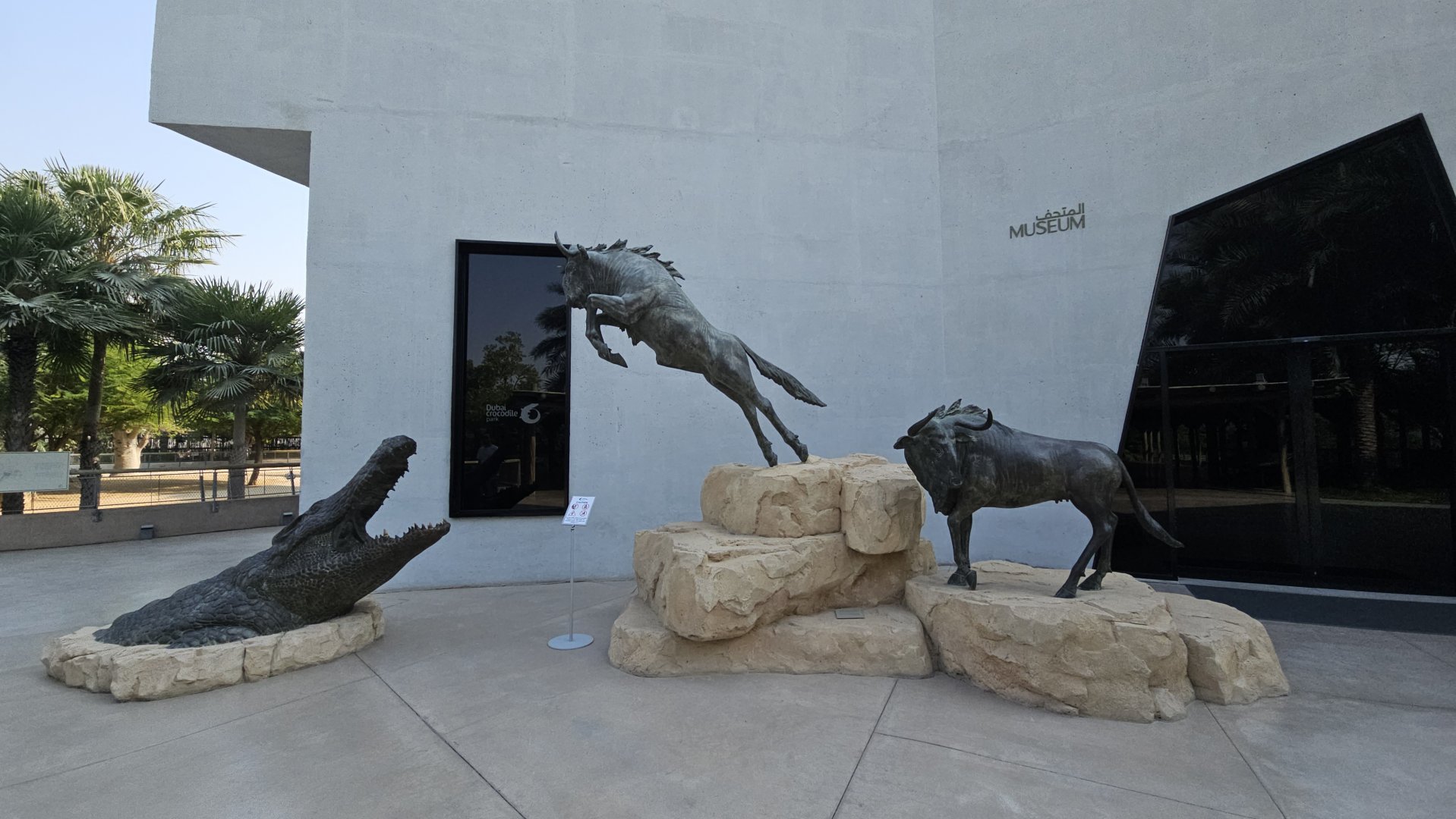 African statues crocodile and wildebeasts, Dubai crocodilepark