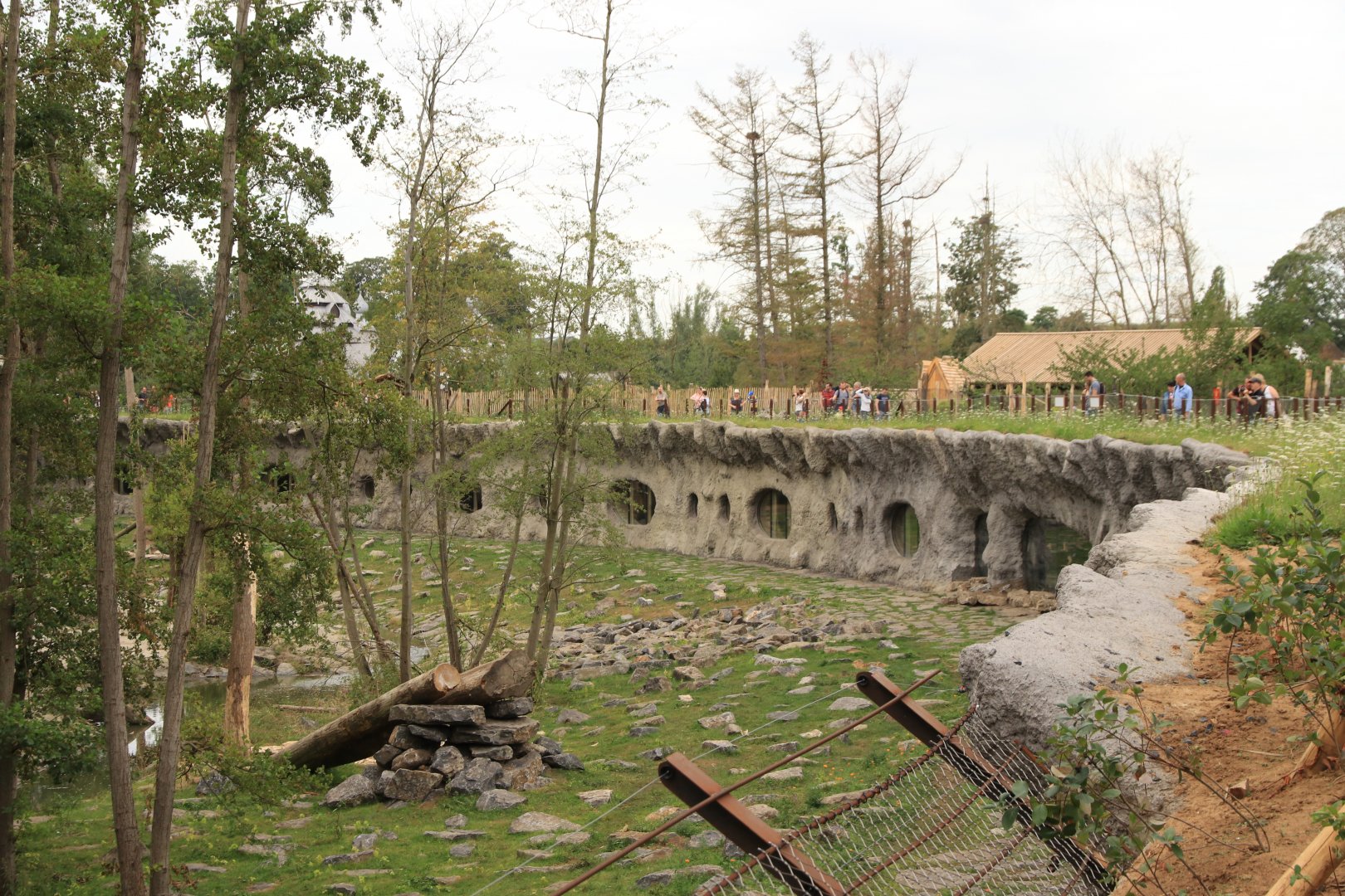Brown bear and grey wolf enclosure with windows of new full moon lodges (hobbit caves) (July 2019)