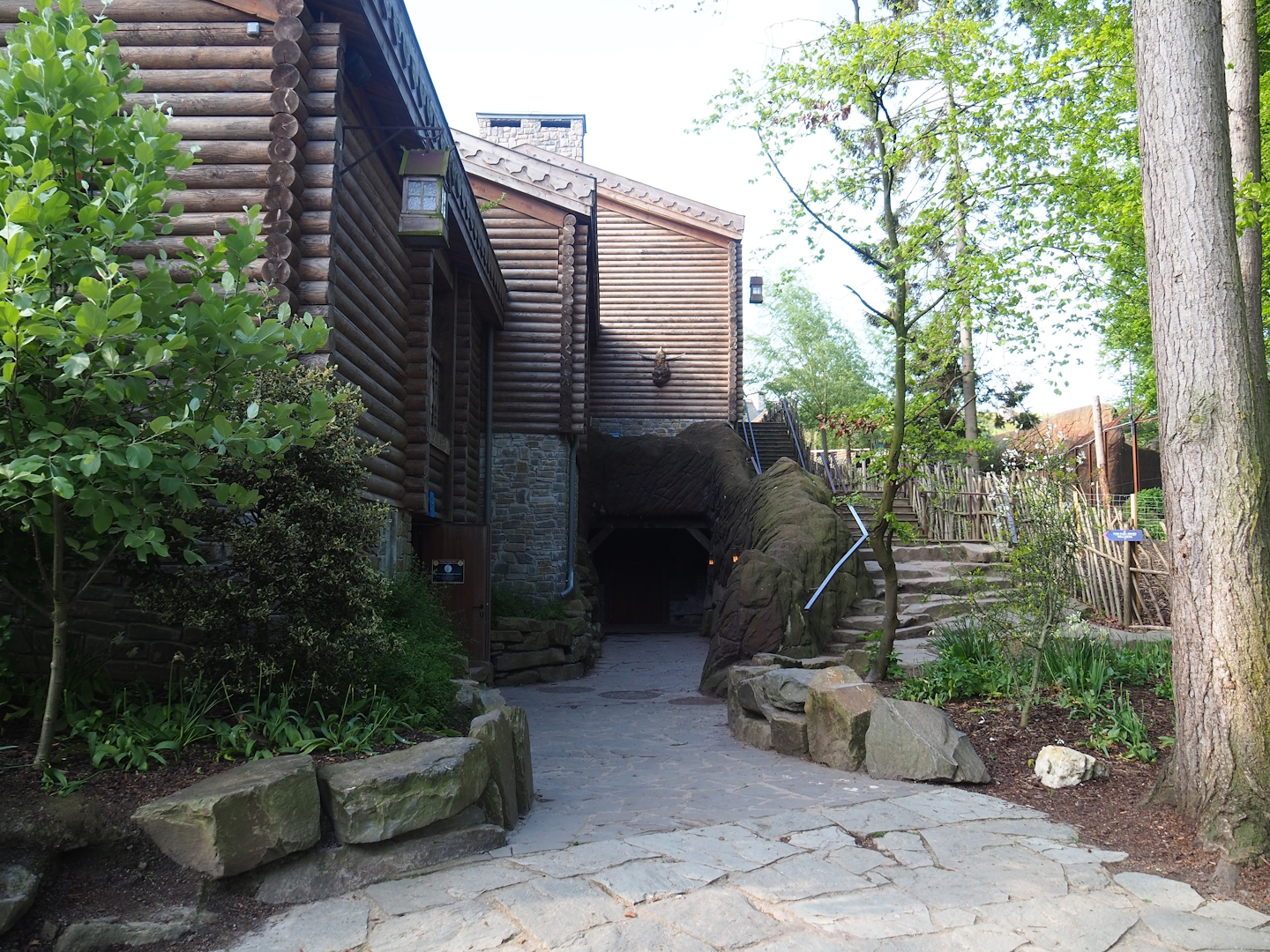 Building with penguin cave, restrooms and hotel rooms, and stairs alongside reindeer paddock, 2023-05-16