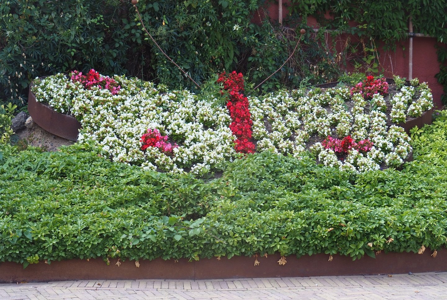 Butterfly shaped planter with flowers near the entrance (Aug 28th, 2018)
