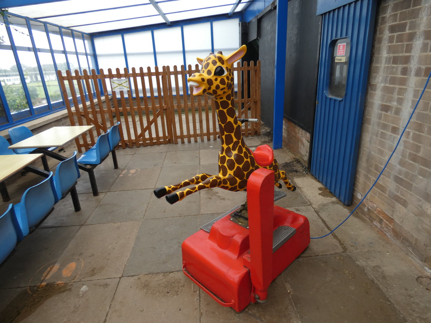 Coin-operated giraffe ride