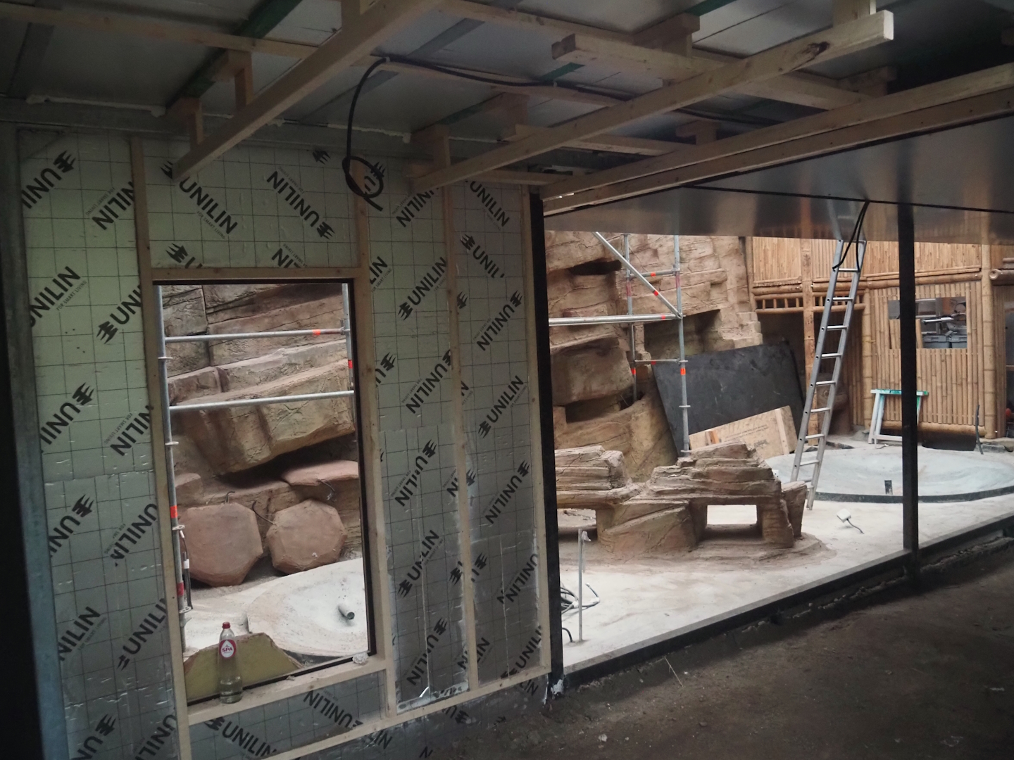 Construction on the indoor aviary in the orangutan greenhouse, with new rock work and pools, 2025-03-23
