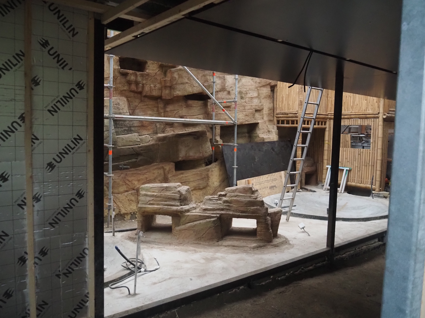 Construction on the indoor aviary in the orangutan greenhouse, with new rock work and pools, 2025-03-23