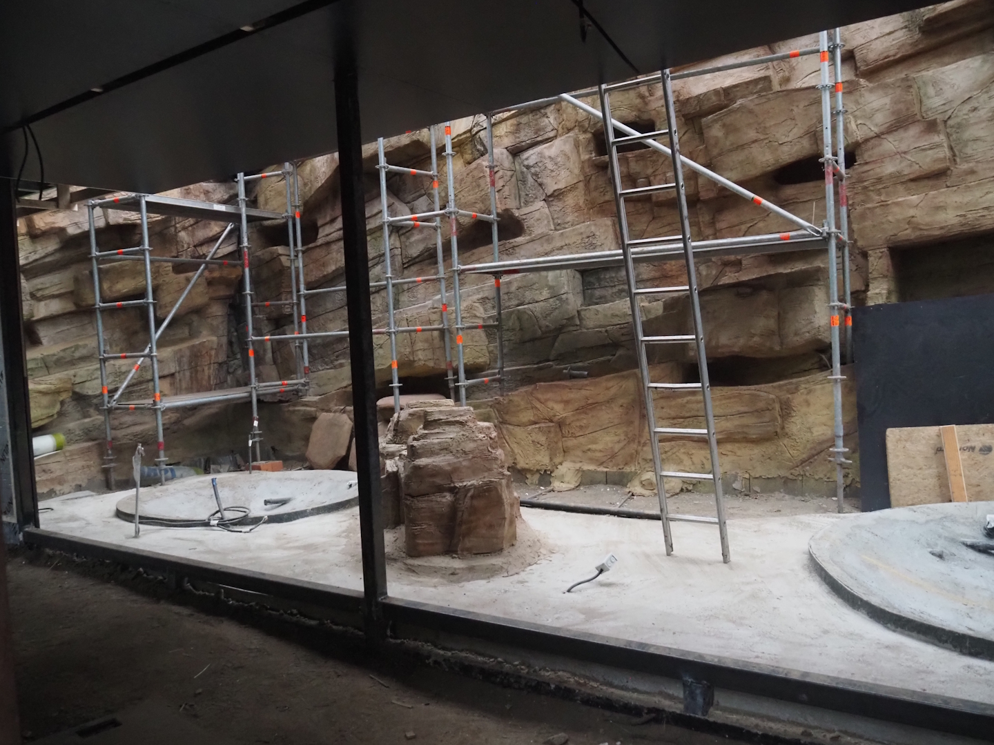 Construction on the indoor aviary in the orangutan greenhouse, with new rock work and pools, 2025-03-23