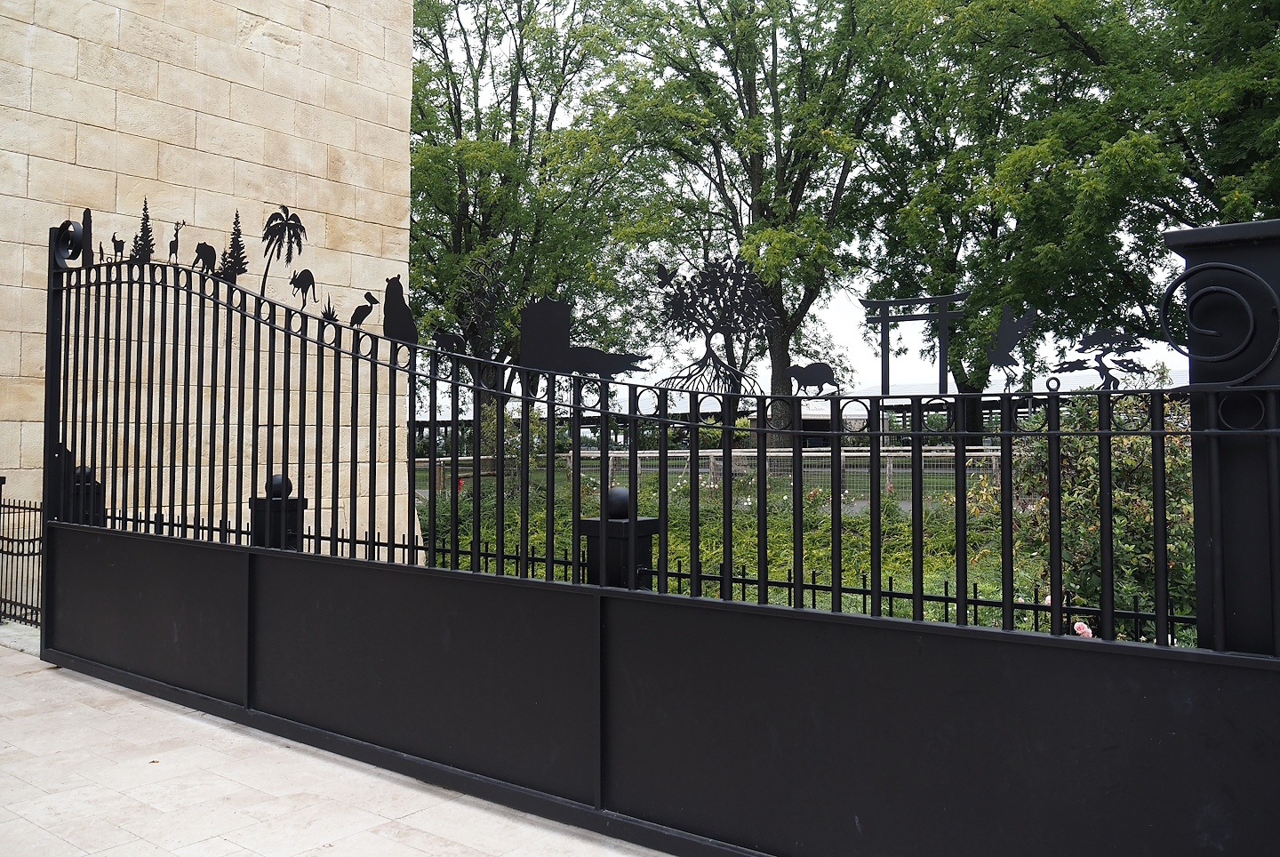 Entrance gate with metal cut-outs representing Pairi Daiza's worlds, 2024-09-17