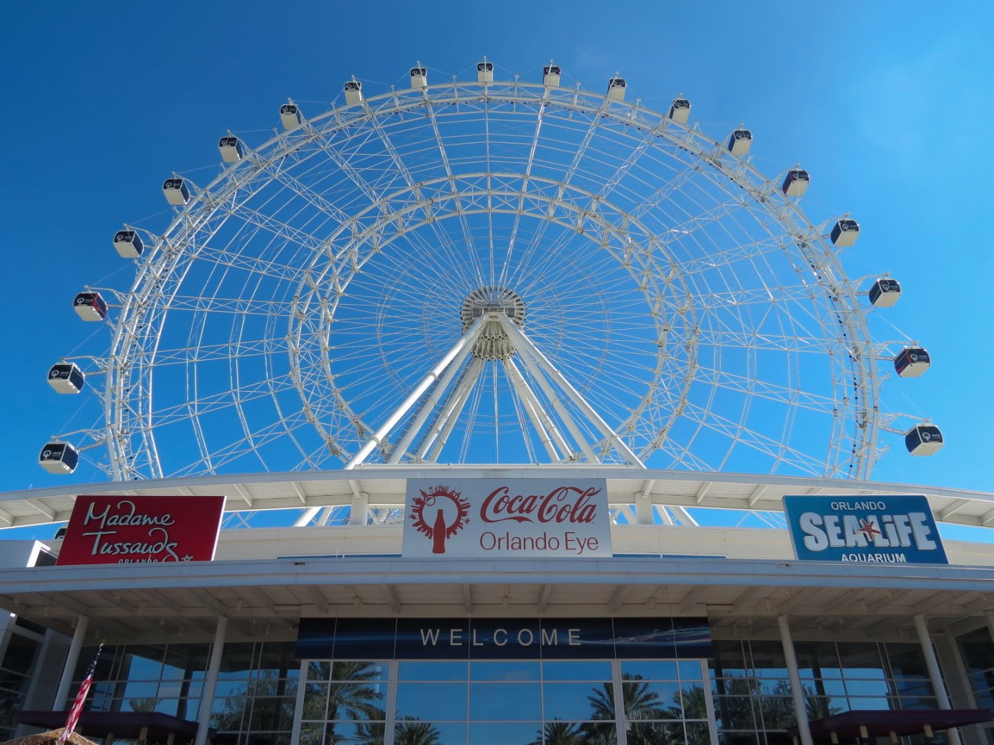 Exterior with Orlando Eye rising above I Drive 360 entertainment complex