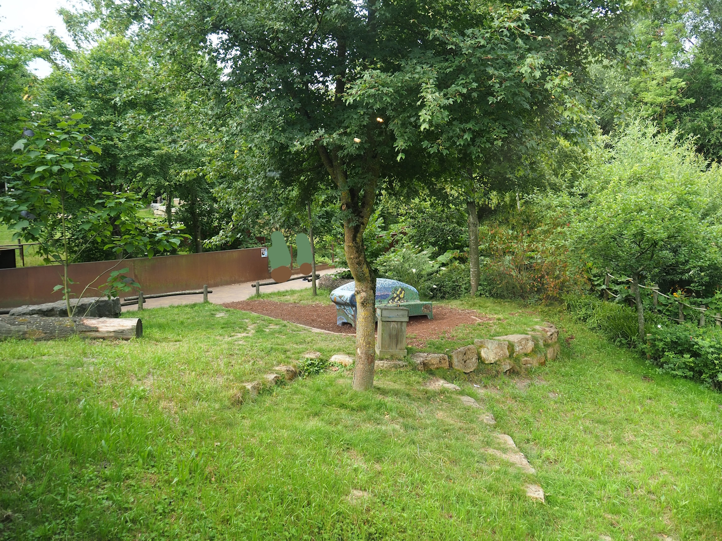 Gardens with bench and walkway with European mink viewing in the background, 2023-07-18