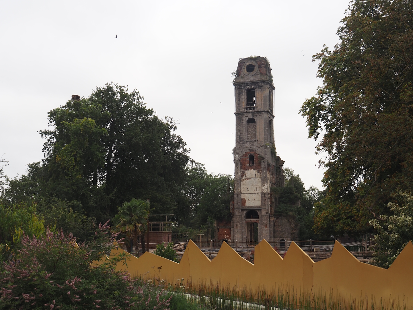 Golden egg shell wall of "Egg of the World' entrance area and old abbey tower, 2024-09-17