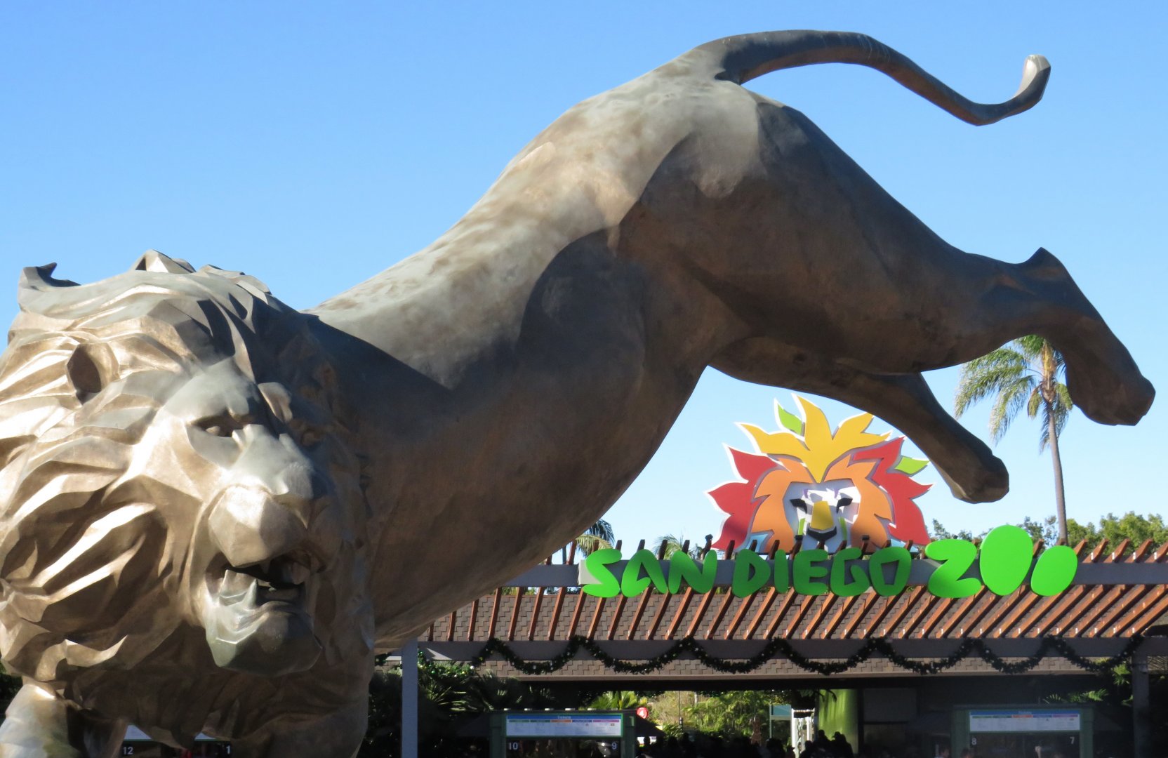 Lion statue and zoo entrance sign