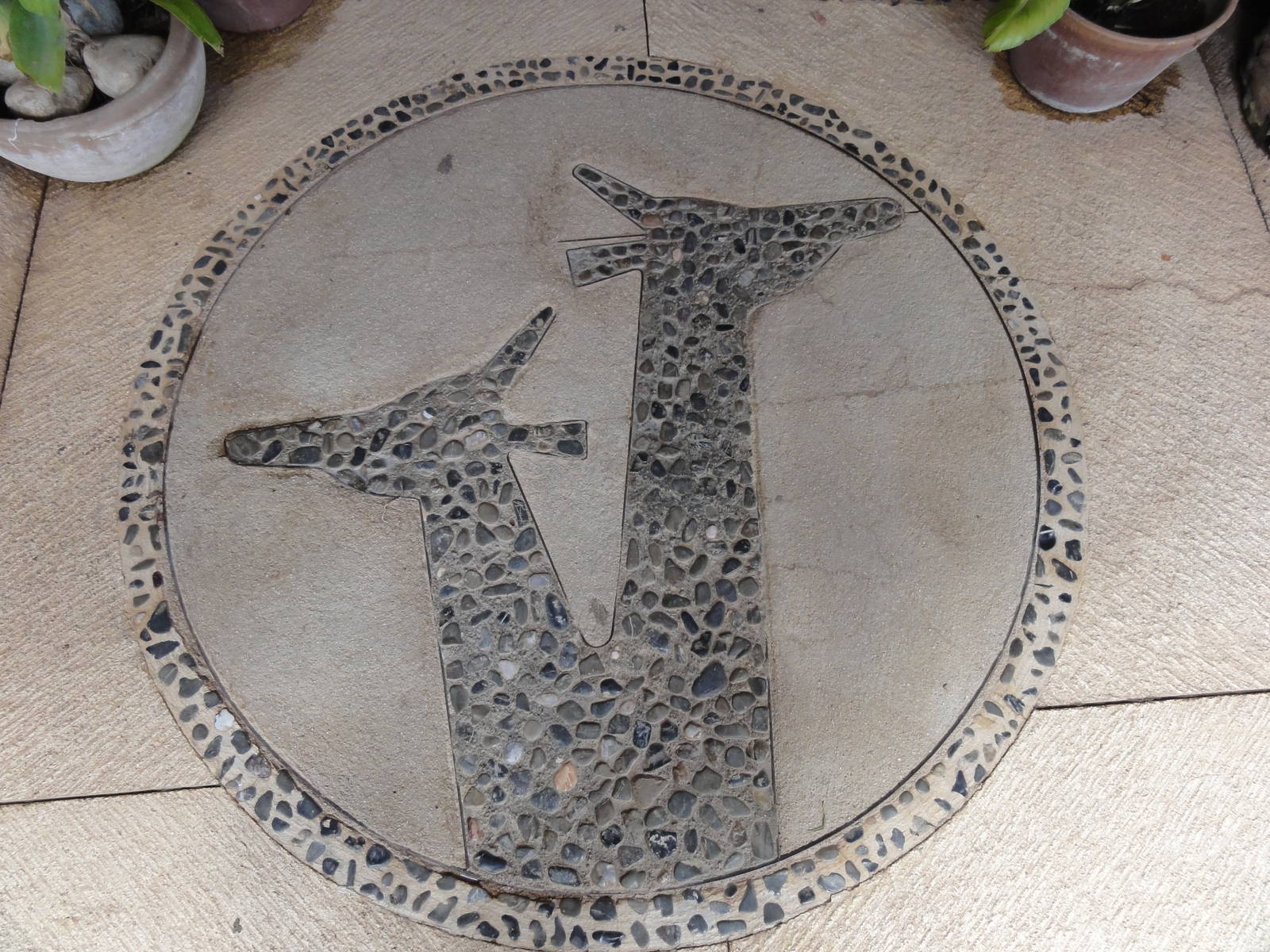Logo mosaic in front of shop