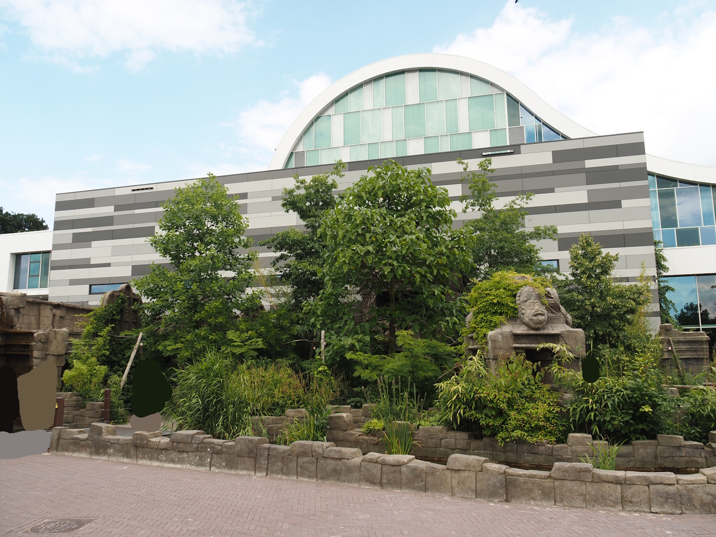 Monkey Ruins exhibit next to entrance building and entrance square, 2024-06-23