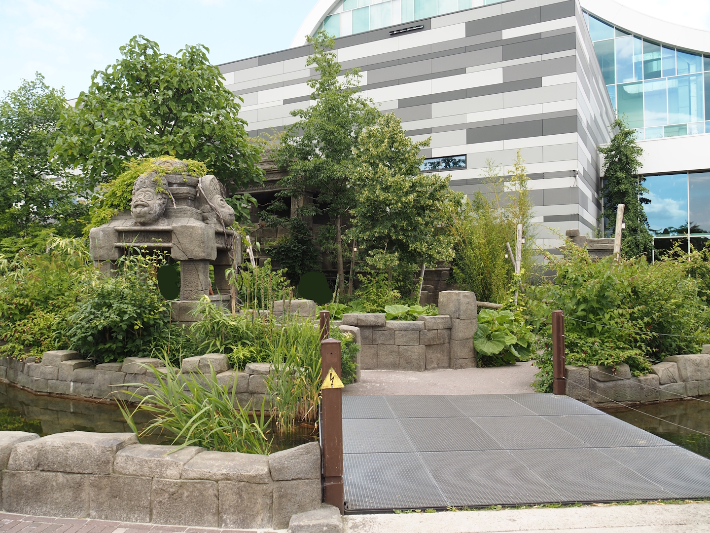 Monkey Ruins exhibit next to entrance building and entrance square, 2024-06-23