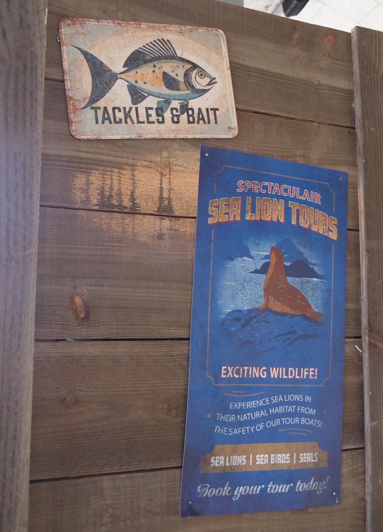 Nortica Hafên port themed area - Examples of fake advertisements in former sea lion theater, 2024-06-23