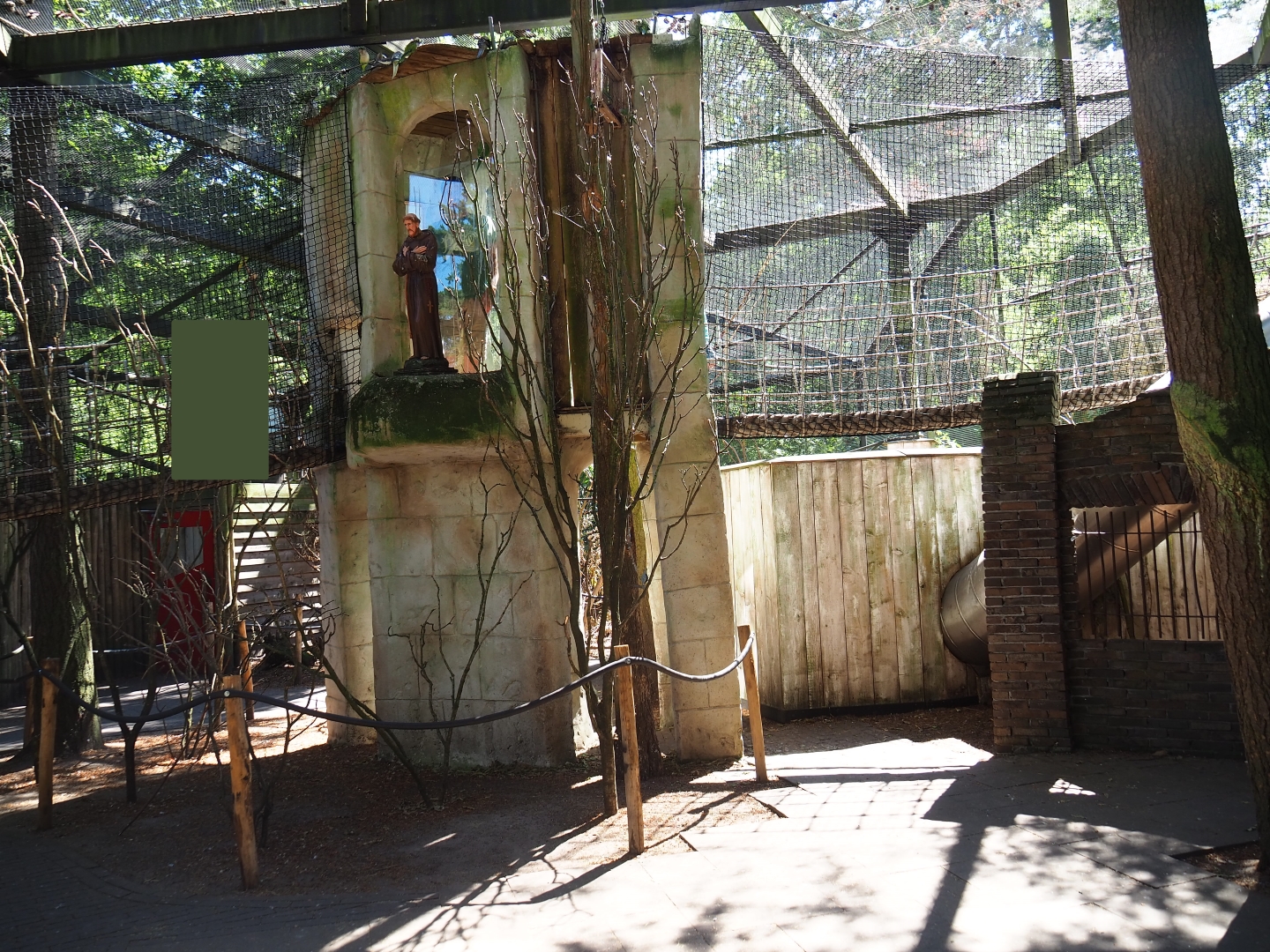 Parakeet aviary (with monk statue)