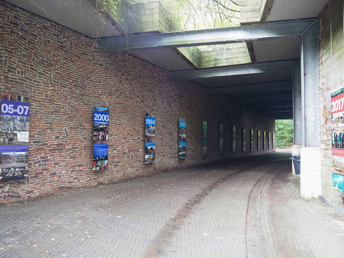 Partially covered walkway with history signage, 2023-10-07