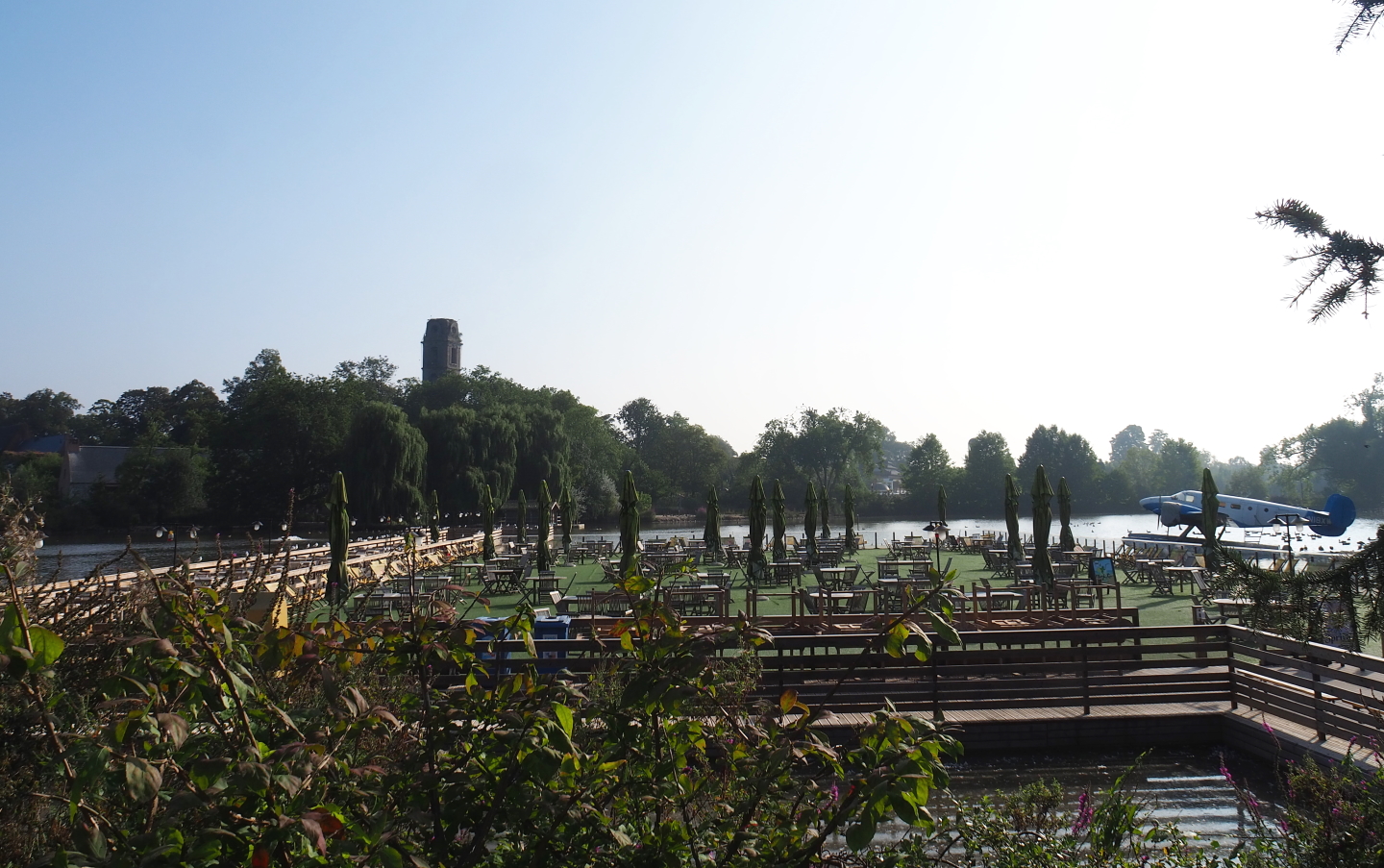 Pontoon terrace on the lake, with floatplane and old abbey tower in the background, 2021-09-02