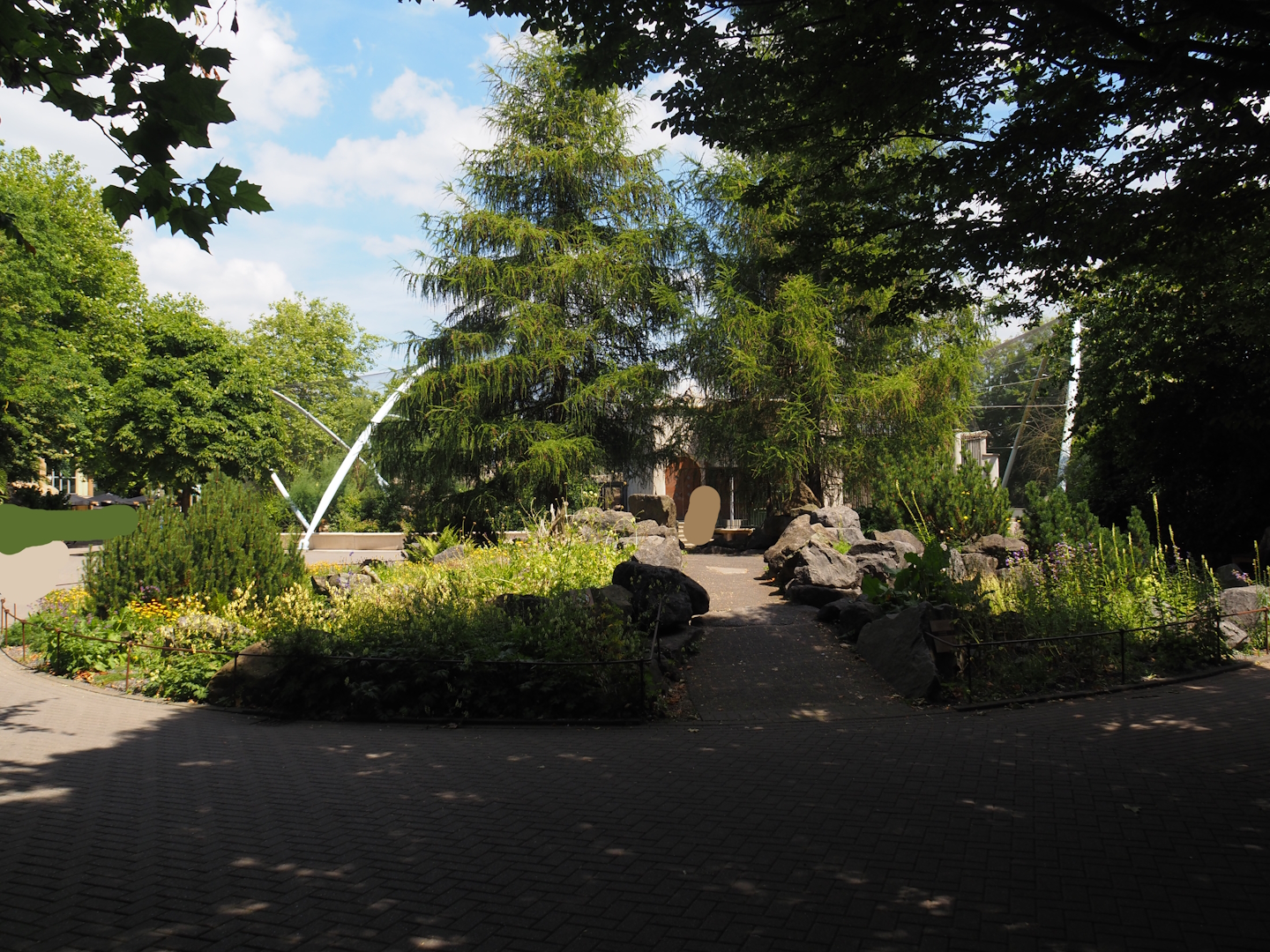 Rock garden at former site of rotunda building with small cat exhibits, 2024-06-30