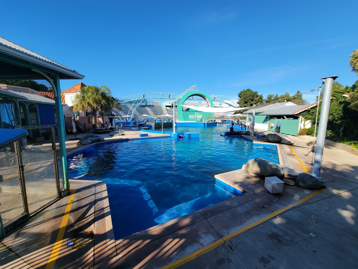 SeaWorld San Diego - Dolphin Adventures off-show pools, with Linne's sloth exhibit on left