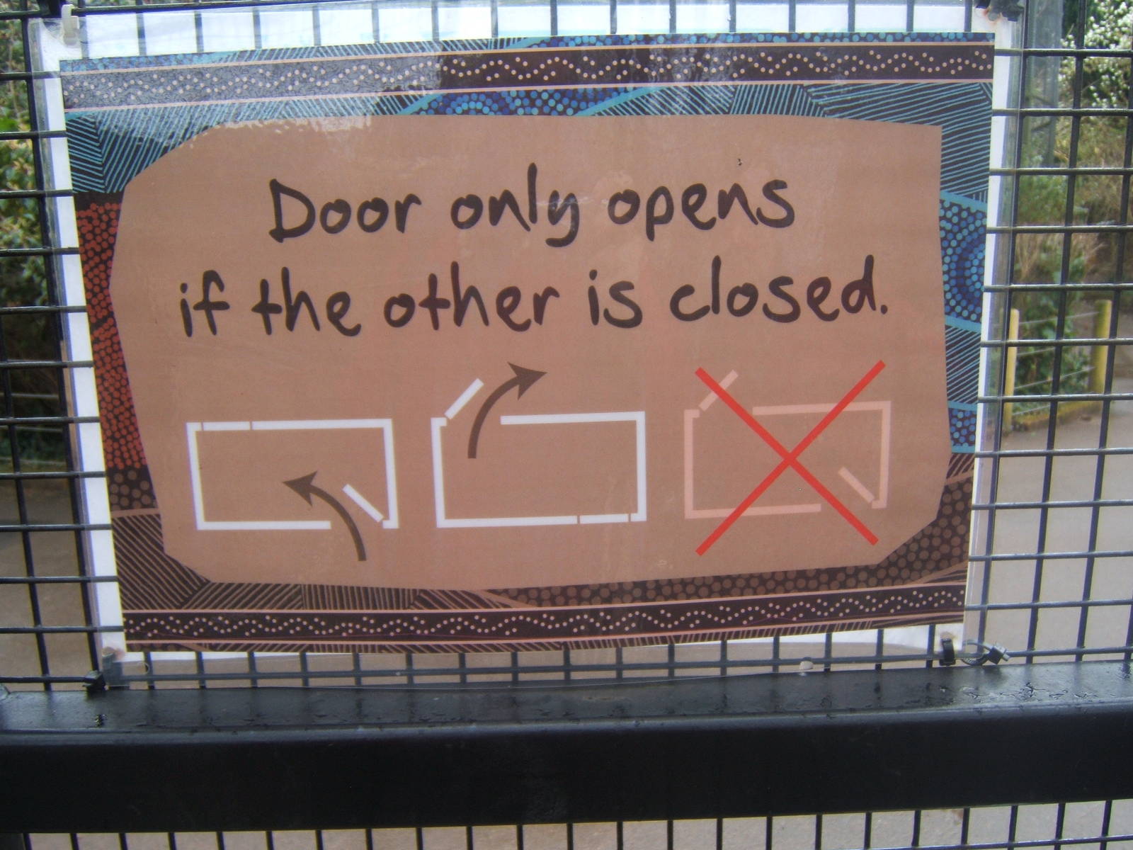 Sign explaining how interlocking doors work