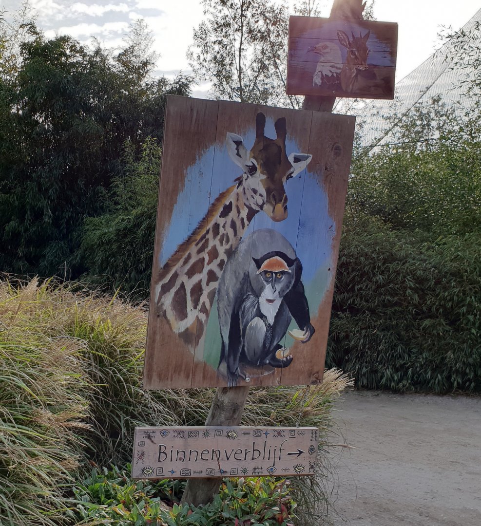 Sign Giraffe and DeBrazza monkey indoor enclosures
