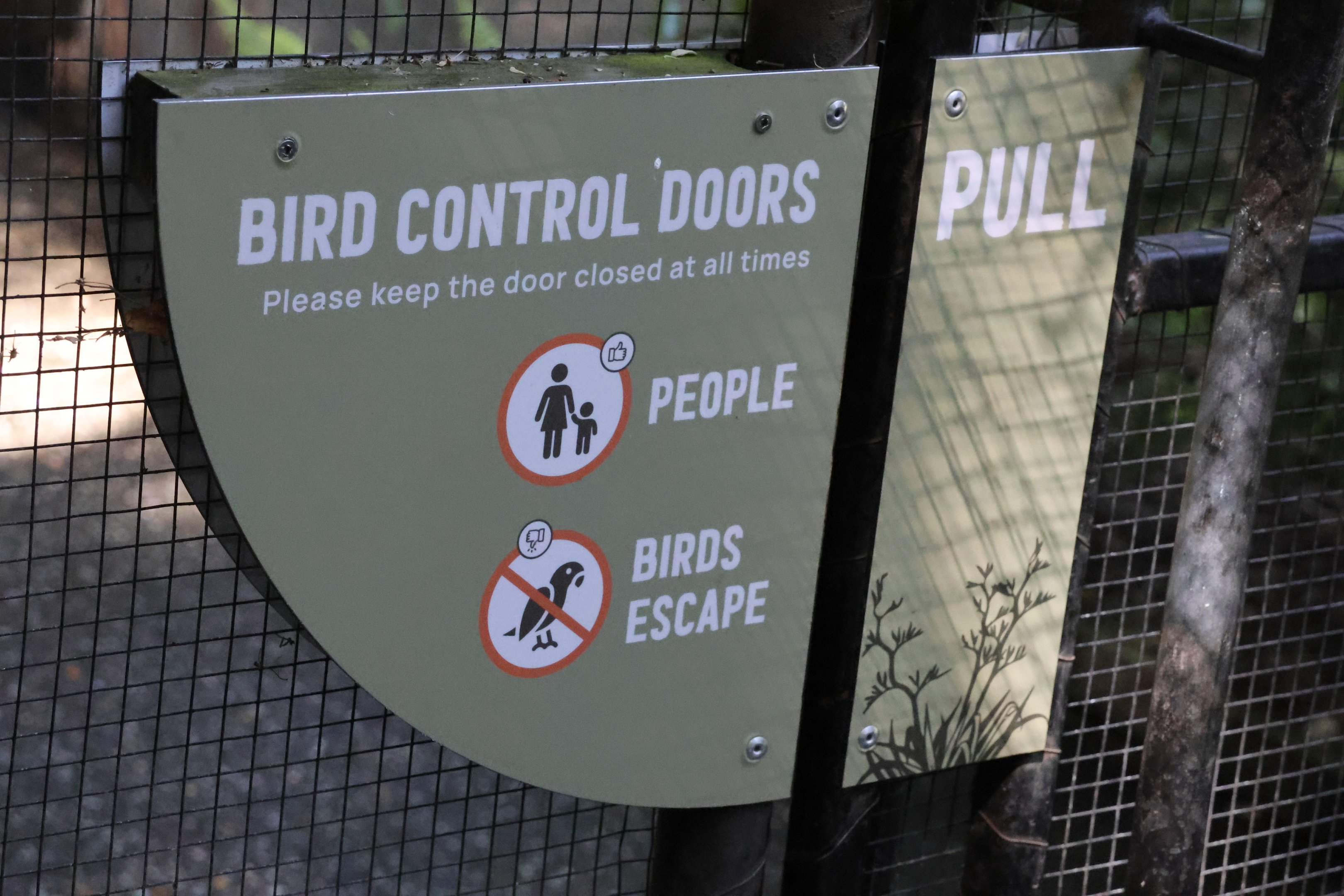 Sign to entrance of mixed Kererū and Red-crowned Kākāriki walk-through aviary