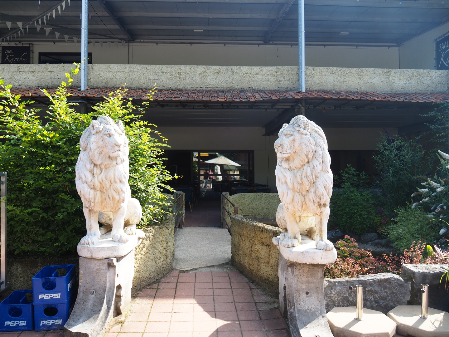 Slider turtle and koi pond with bridge and lion statues near restaurant building, 2019-06-01