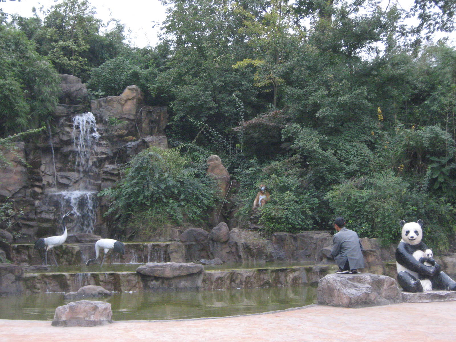 statues by a waterfall