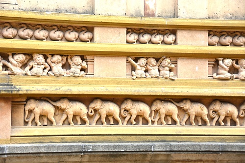 Stone carvings around large building.