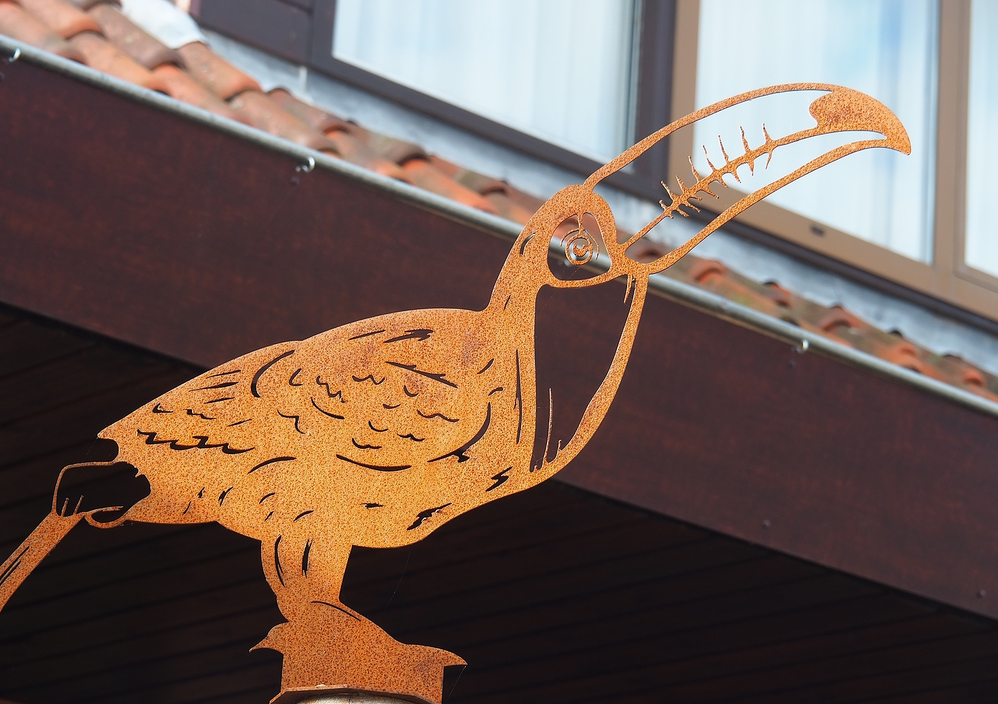 Tucan metal cut-out artwork on top of map, 2022-08-28